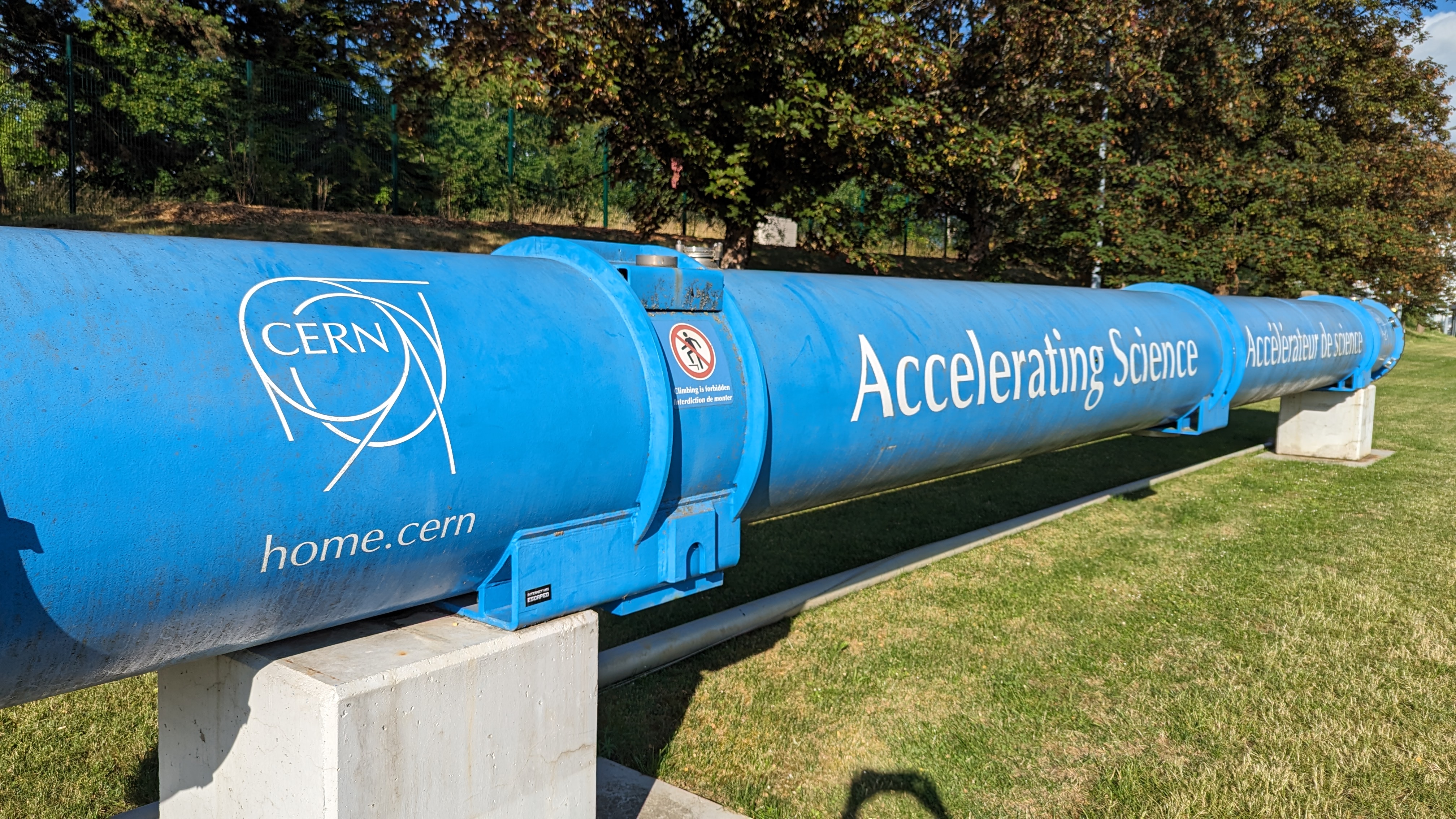 Blue CERN accelerator component outdoors bearing the words Accelerating Science.